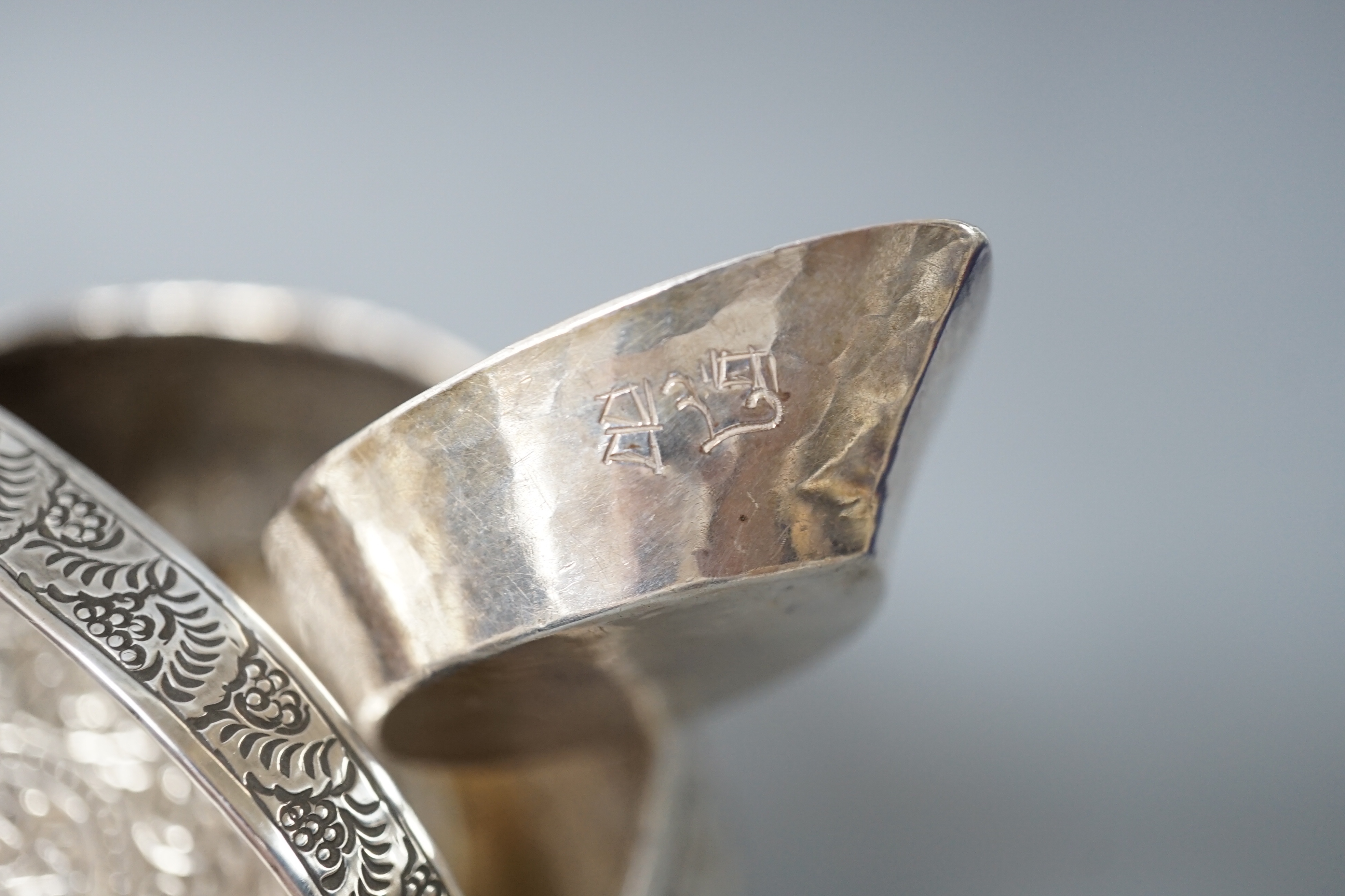 A Burmese? white metal bonbon basket, height 10.1cm and a similar bowl, two Persian white metal boxes and a spoon.